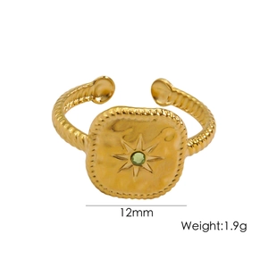 Detail view of gold square signet ring with green gem and star, 12mm width and 1.9g weight