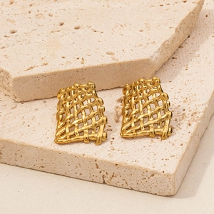 Macro shot of gold rectangular woven mesh earrings with a premium metallic texture