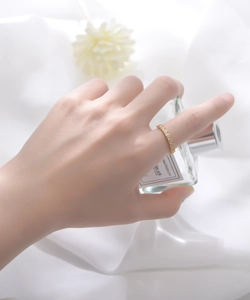 Detail of s925 silver golden ring with continuous heart shapes and micro-inlaid zircons