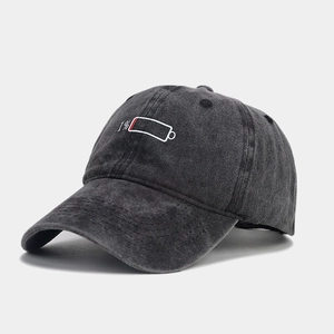 Detailed view of 1% low battery embroidery on washed cotton vintage baseball cap