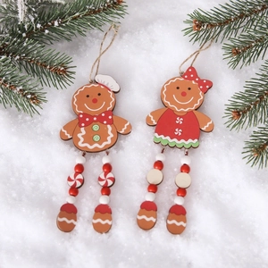Wooden gingerbread man Christmas tree ornaments with red beads on a snowy background