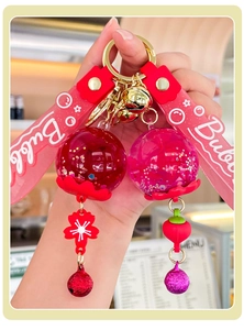 Detail of red and pink bubble keychains with glitter acrylic balls and soft silicone straps