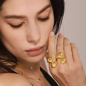 Irregular organic geometric gold ring with high polish finish shown on model