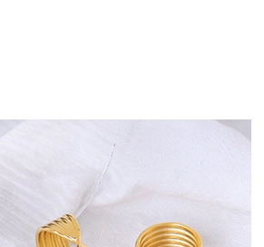 Detailed view of polished 18K gold-plated C-shaped earrings with spiral layered texture