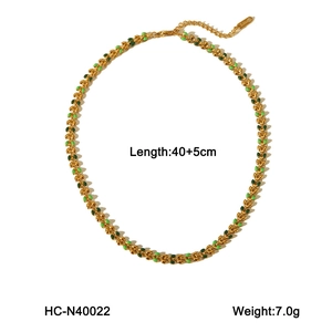 Detail view of gold titanium necklace showing green enamel olive leaves with 40+5cm length