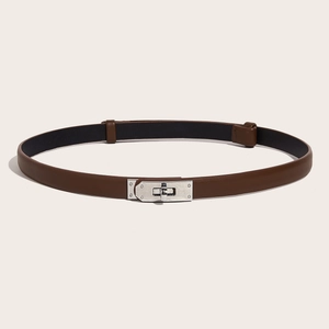 Detailed view of brown leather skinny belt featuring a polished silver swivel lock buckle