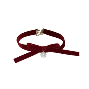 Elegant burgundy velvet bow choker necklace with a dangling white pearl charm and silver clasp