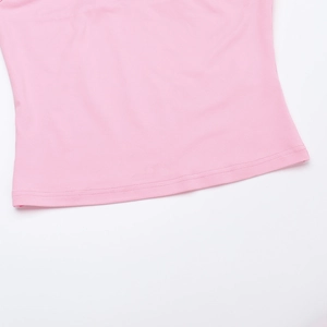 Detailed close-up of pink knit fabric hem with precise stitching and fine texture
