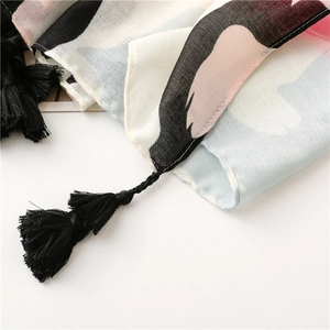 Close-up of tropical floral woven scarf with black tassels and premium chevron texture