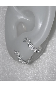 Close-up of minimalist silver U-shaped earrings with zircon inlay on model display