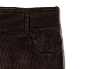 Detailed view of dark brown corduroy mini skirt waist with belt loops and side pockets