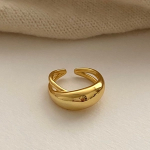Modern gold-finish geometric crossover open ring with a polished minimalist aesthetic