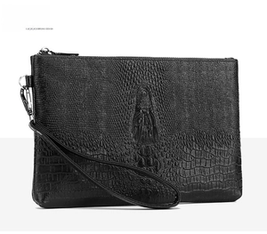 Detailed view of the black crocodile pattern texture and silver zipper on men's clutch