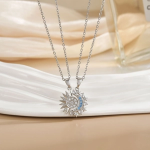 Detail of sun and moon interlocking pendants with micro-pave cubic zirconia on silver chains