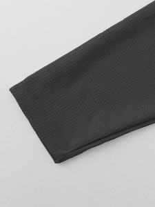 Detailed close-up of dark grey waffle knit fabric texture and cuff stitching on men's set