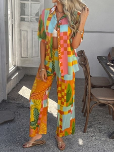 Detail of bohemian geometric print short-sleeve shirt and wide-leg trousers on resort balcony