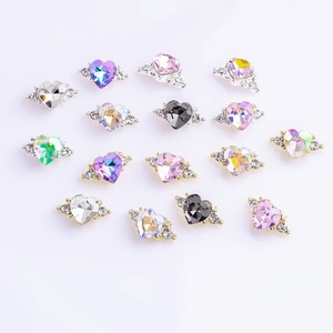 Macro shot of 3D heart-shaped nail gems with sparkling wings in various colors