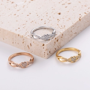 Three minimalist stainless steel infinity heart rings in gold, silver, and rose gold finishes