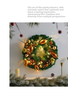 Detail of Christmas pine wreath with gold ornaments, pine cones and warm LED lights