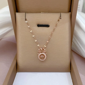 Detail of rose gold reindeer antler necklace with a shimmering floating zircon gemstone