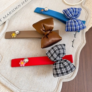 Three-piece floral bow hair clip set with rhinestones and vintage duckbill design