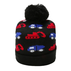 Detail of knitted beanie for kids with excavators patterns and soft black pompom