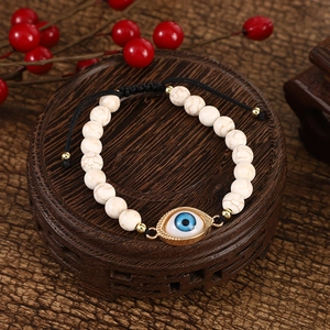 Detail of turquoise evil eye bracelet with white marble beads and adjustable cord