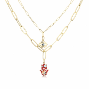Detail of 18K gold double-layer necklace with Hamsa hand and Evil Eye enamel pendants