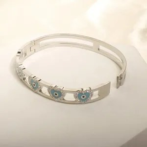 Detail of silver heart-shaped evil eye bracelet with blue crystals and white zircons