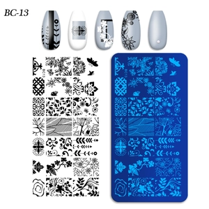 Macro detail of BC-13 nail stamping plate with floral patterns and finished nail tips