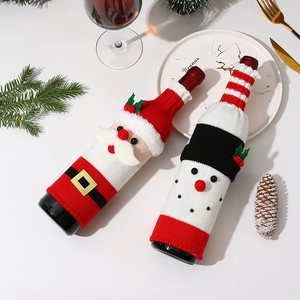 Festive knitted Santa and Snowman wine bottle covers set on a decorated holiday table