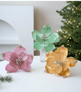 Detail of fabric magnolia flowers with gold glitter edges and crystal beads for Christmas