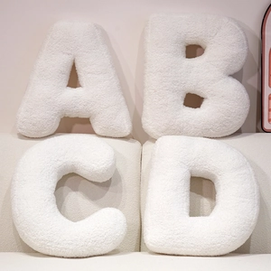 White teddy fleece alphabet letter pillows A-D set on sofa for home decor