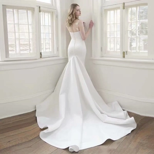 Elegant white satin mermaid wedding dress with long train and decorative back buttons