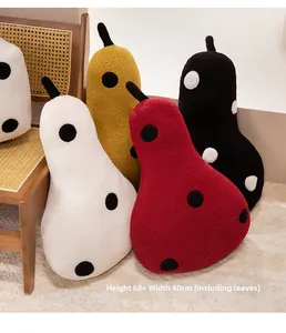Detail of four colorful polka dot pear pillows in cozy teddy fleece fabric, size 68x40cm
