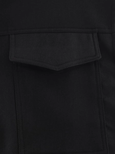 Close-up of black twill fabric featuring a flap pocket and durable double-stitch details