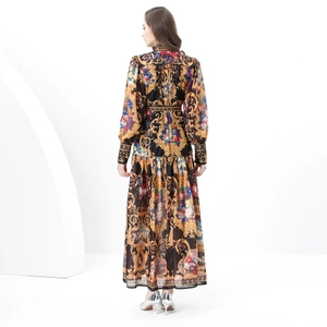 Back view of baroque print maxi dress with stand collar and lantern sleeves in gold and black