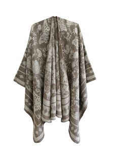 Detailed close-up of brown and beige knitted shawl with vintage floral and butterfly patterns