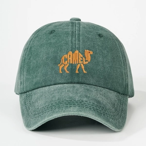 Close-up of orange camel embroidery on washed green cotton vintage baseball cap