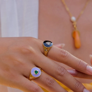 Close-up of 18K gold plated stainless steel heart enamel rings with zircon stones