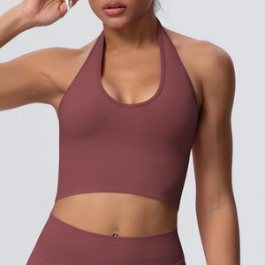Close-up of halter neck sports bra in rose pink with ribbed texture and slim fit design