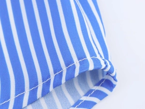Macro shot of vertical blue and white stripes fabric with detailed stitching quality