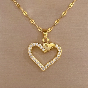 Macro detail of a heart pendant necklace with shimmering zircon stones and gold finish