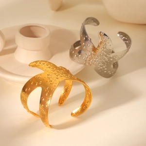 Hammered starfish cuff bracelet in gold and silver finish with detailed metal texture