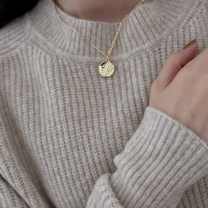 925 sterling silver wavy coin necklace with gold hammered pendant on knit sweater