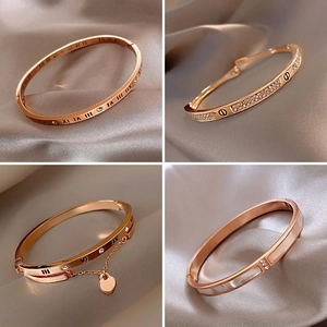 Macro shot of rose gold bracelets with Roman numerals and cubic zirconia inlay