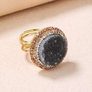 Macro shot of dark grey druzy agate ring with multi-row crystal pavé and gold multi-band
