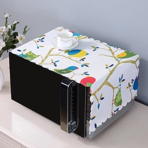 Detailed view of linen microwave dust cover with colorful birds and scalloped edges