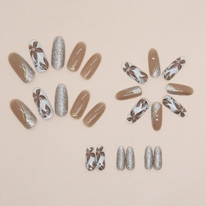 Brown floral press-on nails with silver glitter, rhinestones, and oval design