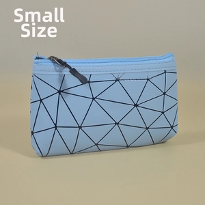 Detail view of a blue geometric makeup bag with a 3D triangle pattern and blue zipper